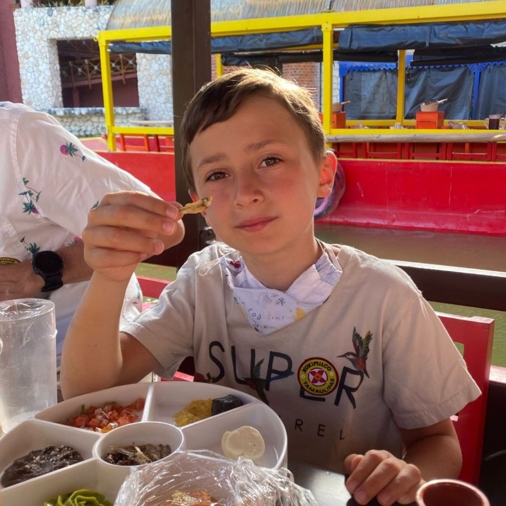 Young boy enjoying Mexican appetizers