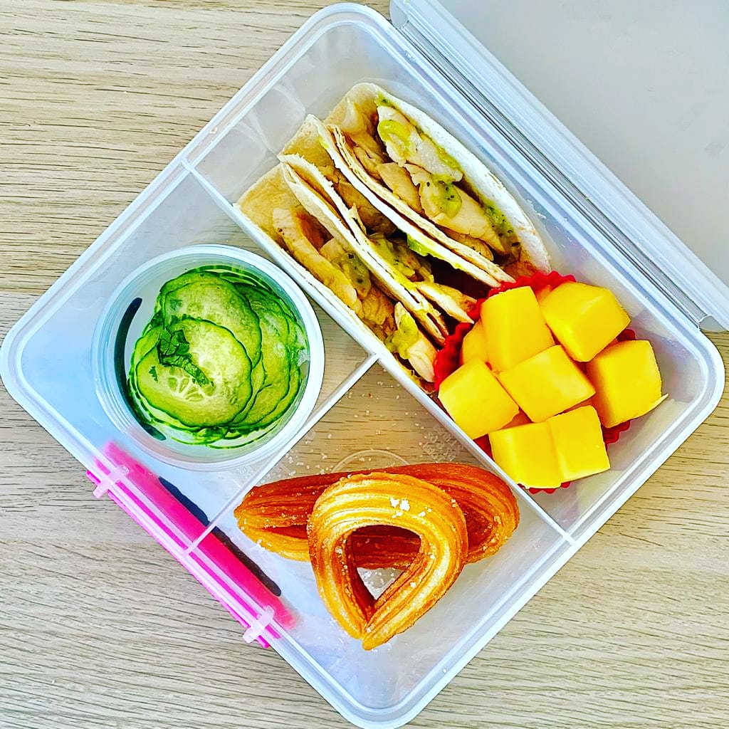 Chicken and guacamole tortilla wraps in a Mexican-themed lunchbox