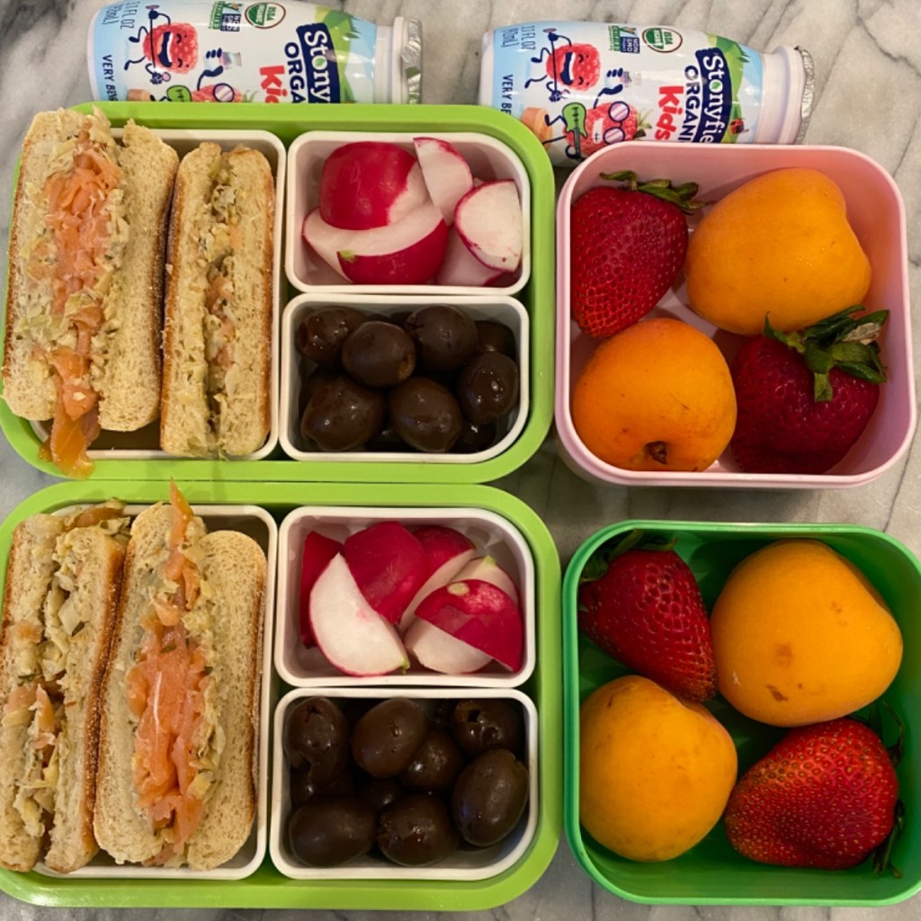 Kid’s lunchbox featuring simple crunchy radish bites paired with artichoke-salmon sandwiches, a nutritious and colorful school lunch idea for balanced eating.