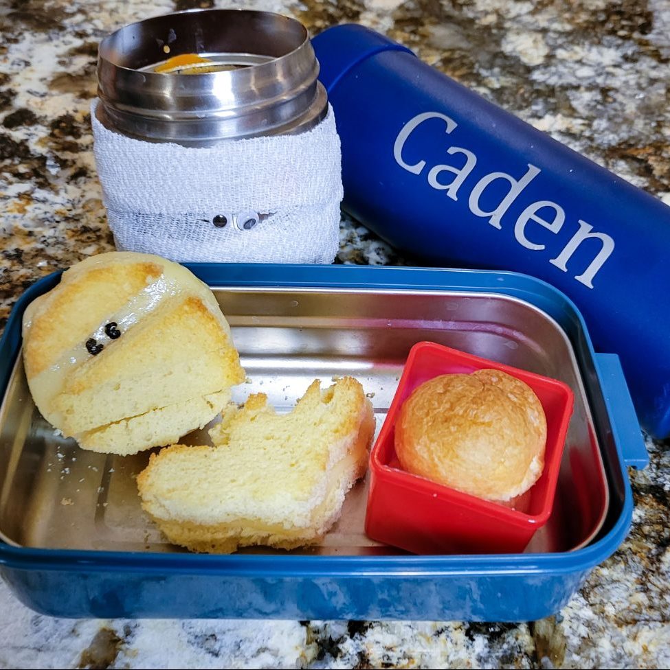 Pair a cozy tomato soup with grilled cheese sandwiches wrapped mummy-style using strips of bread or cheese.