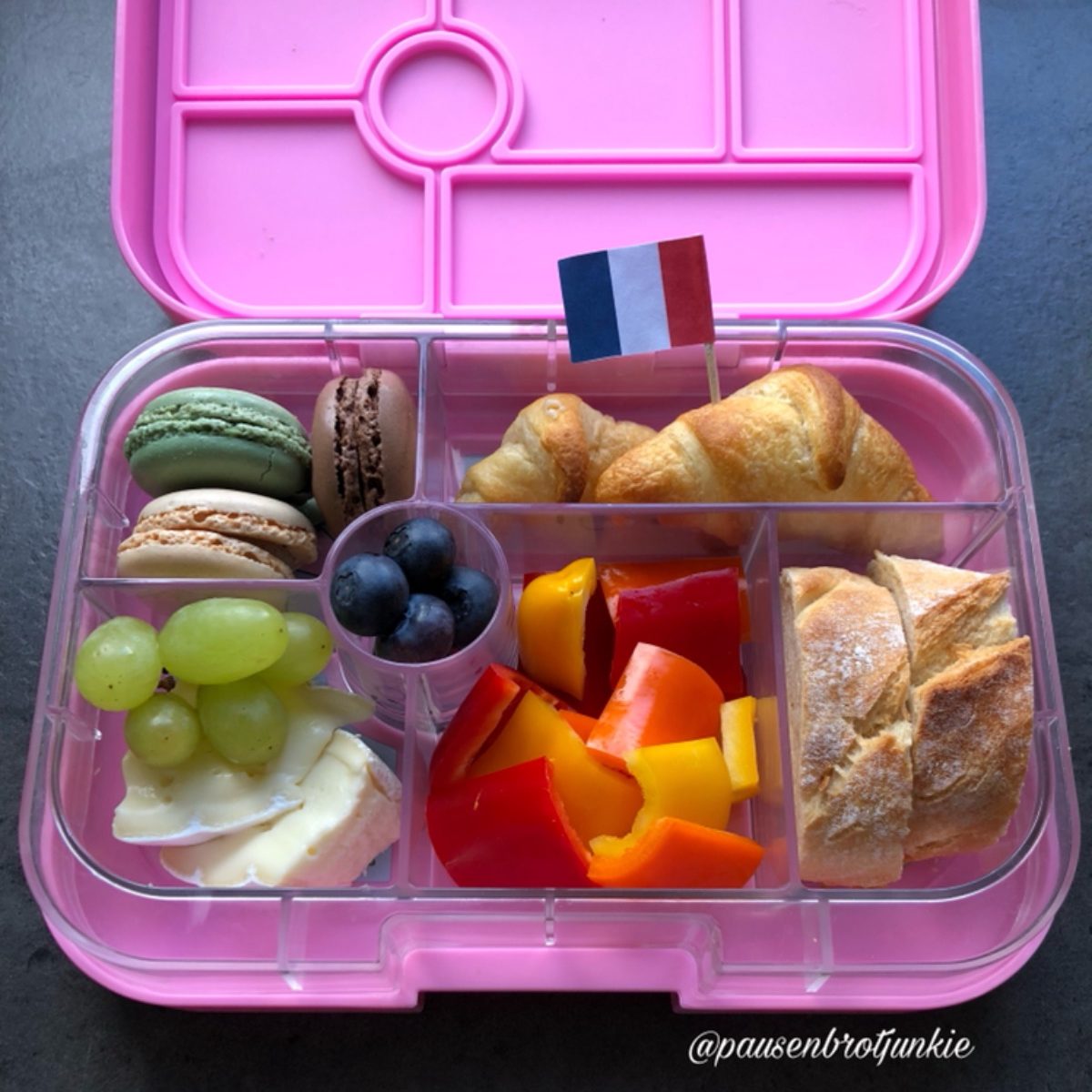 French-style picnic in a pink lunchbox for a kid's lunch at school