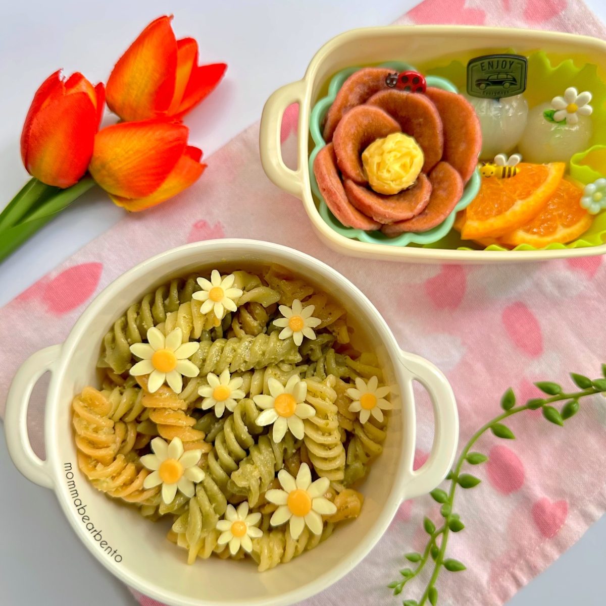 Cheesy flowers on top of rotini pasta for a beautiful flower-themed kid's lunch