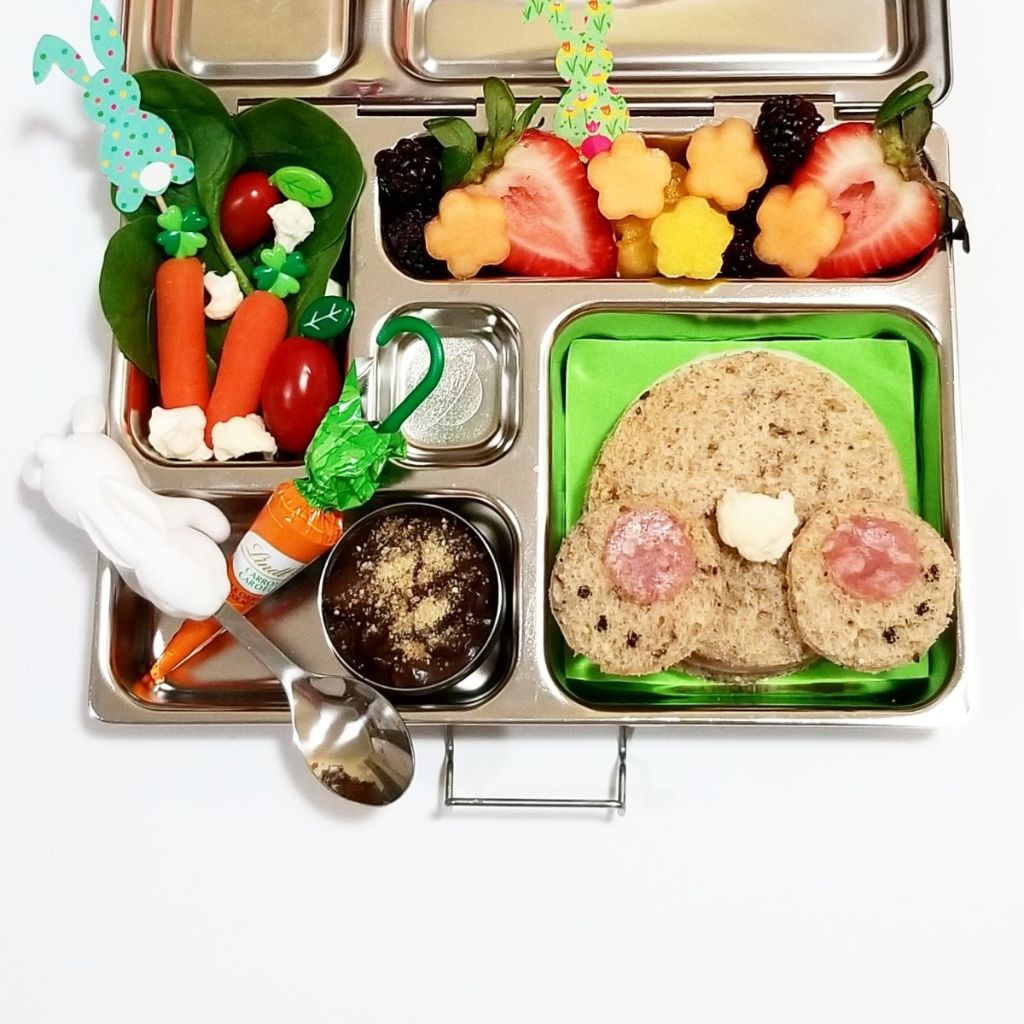Festive Easter lunchbox with rabbbit sandwich, veggies and fruits to crunch, and a delicious chocolate treat