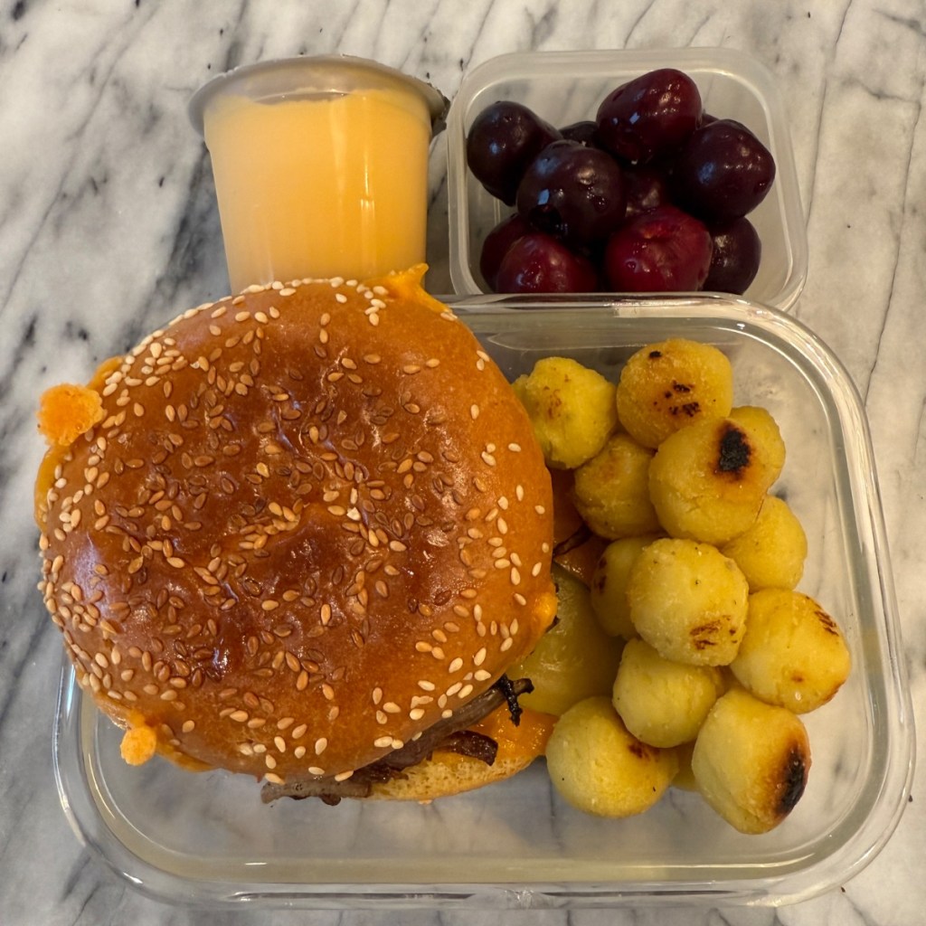 Homemade burger with potato bites for a kid's packed lunch