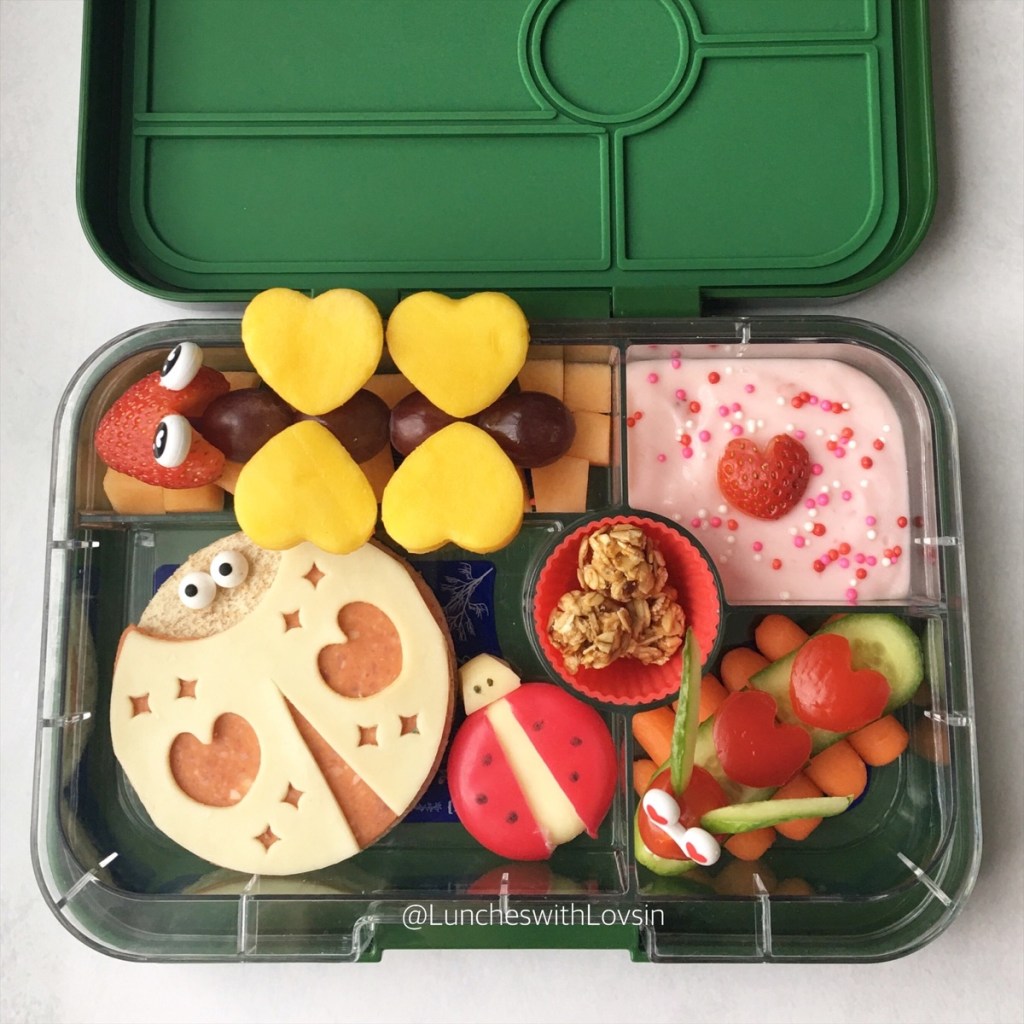 Cute edible ladybugs in a kid's lunchbox, made two ways (open sandwich and with a Babybel cheese).
